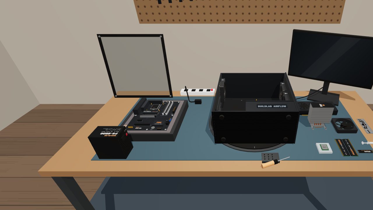 A workbench with an open PC case, motherboard and parts